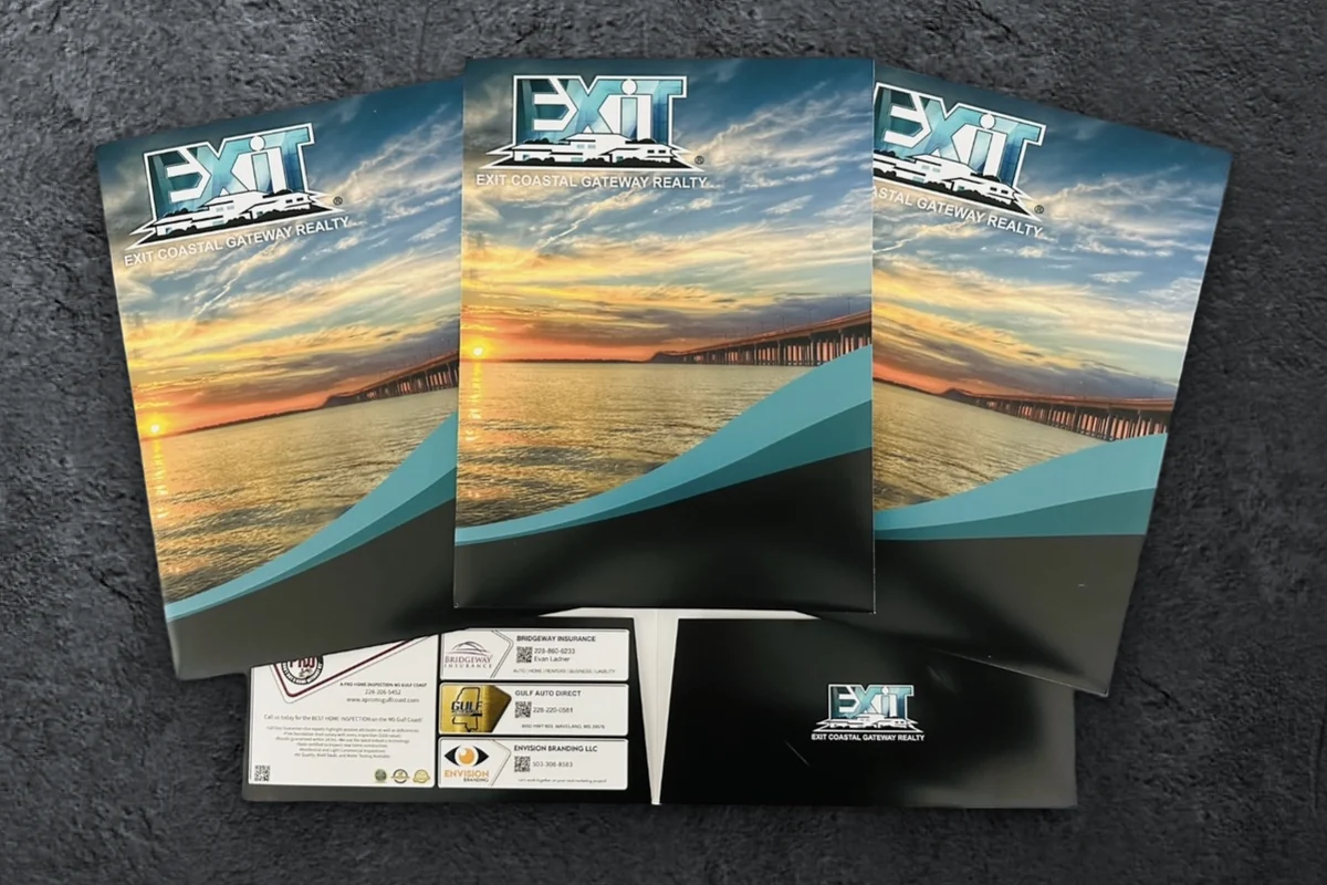 Custom EXIT Coastal Gateway Realty presentation folders with local vendor ads on the pocket