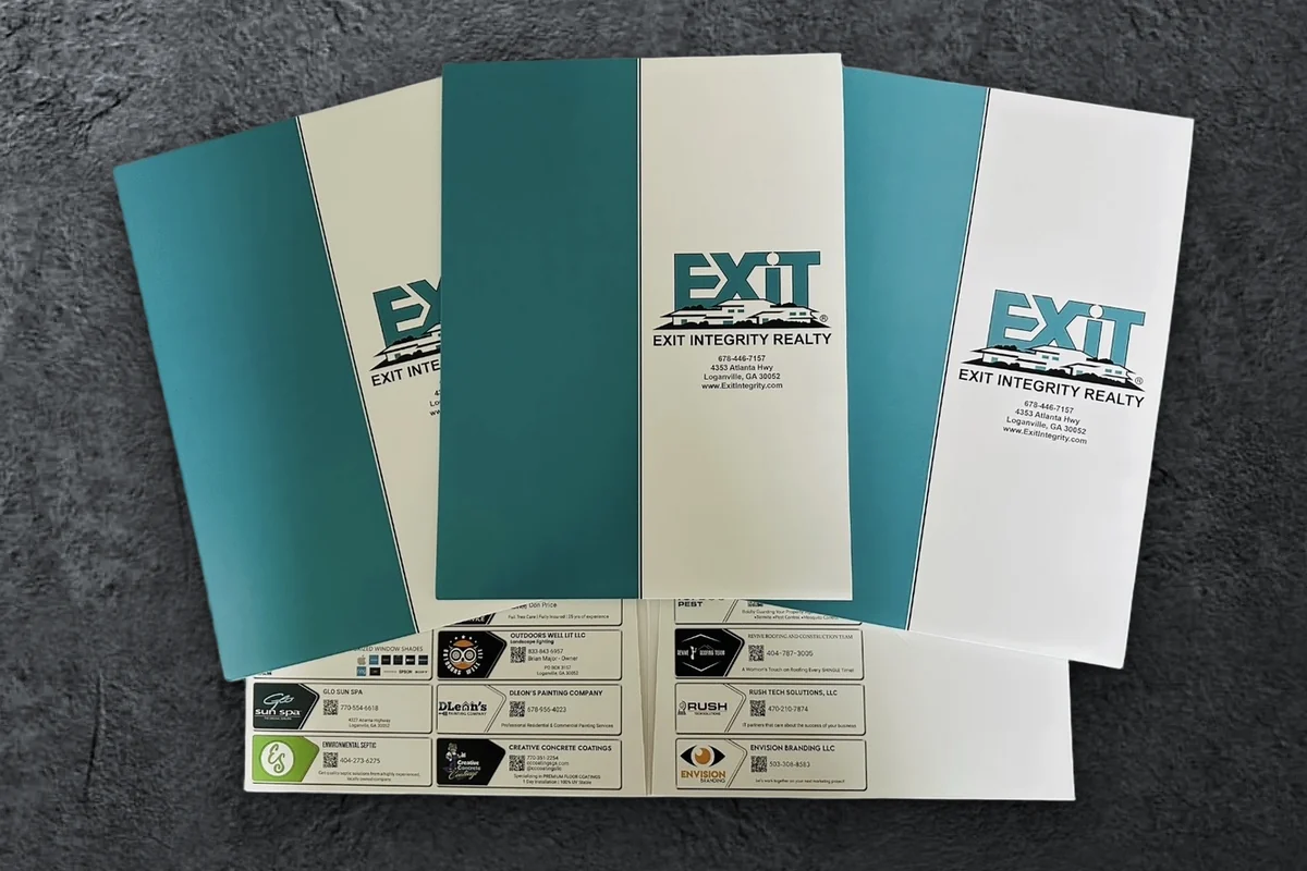 Custom EXIT Integrity Realty presentation folders in teal and white with local vendor ads on the pocket