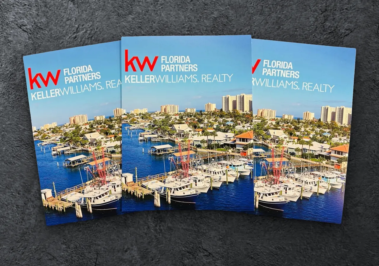 Three custom Keller Williams Florida Partners presentation folders fanned out