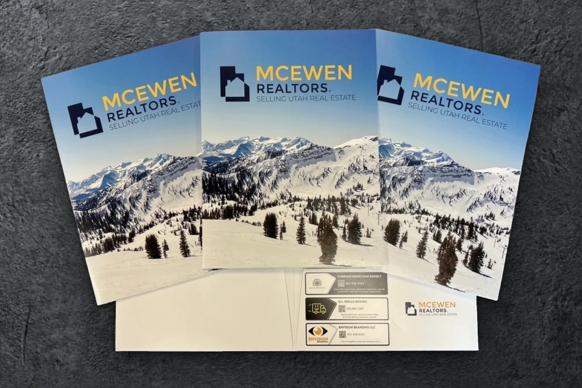 Custom McEwen Realtors presentation folders with local vendor ads on the pocket