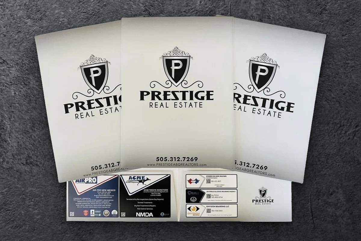 Custom Prestige Real Estate presentation folders with local vendor ads on the pocket