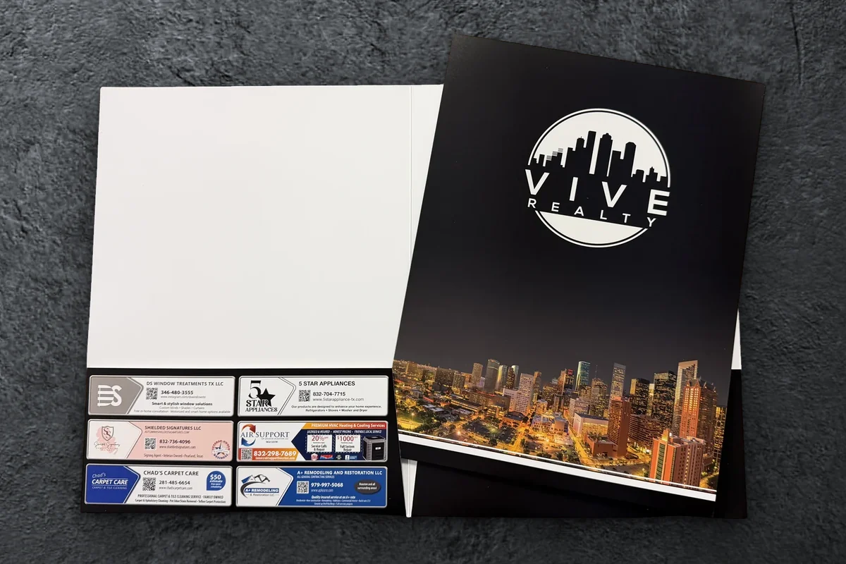 Custom Vive Realty presentation folder, open to show local vendor ads printed on the pocket