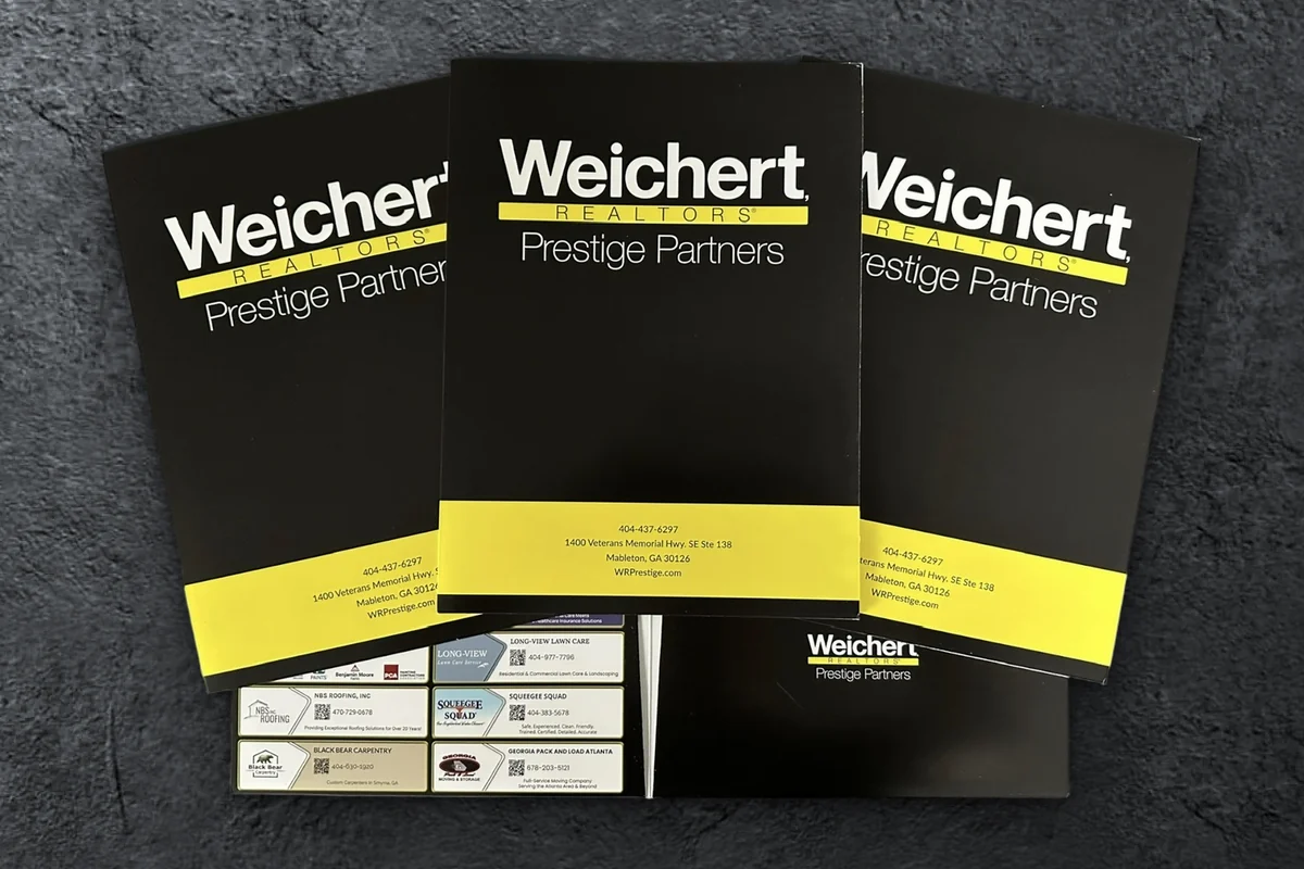 Custom Weichert Realtors Prestige Partners presentation folders in black and yellow with local vendor ads on the pocket